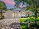 Charming home featuring a three-car garage, manicured lawn, and beautiful brick paver driveway at 3506 Cordgrass Dr, Valrico, FL 33596