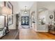 Elegant foyer featuring hardwood floors, a decorative rug, and arched doorways at 3506 Cordgrass Dr, Valrico, FL 33596