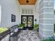 Welcoming front porch with tiled flooring, a comfortable bench, and ornate glass double doors at 3506 Cordgrass Dr, Valrico, FL 33596