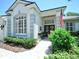 Inviting front entrance with a stone walkway, manicured bushes, and elegant double doors at 3506 Cordgrass Dr, Valrico, FL 33596