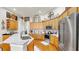 Modern kitchen with stainless steel appliances, granite countertops, and light wood cabinetry at 3506 Cordgrass Dr, Valrico, FL 33596