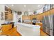 Bright kitchen featuring custom wood cabinets, stainless steel appliances and a large center island with countertop seating at 3506 Cordgrass Dr, Valrico, FL 33596