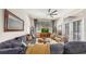 Comfortable living room with vaulted ceiling, blue sofa, and large windows at 3506 Cordgrass Dr, Valrico, FL 33596