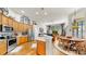 Spacious living area with stainless steel appliances, wood floors, and open floor plan at 3506 Cordgrass Dr, Valrico, FL 33596