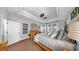 Airy main bedroom boasts tray ceilings, bright windows, and cozy furnishings at 3506 Cordgrass Dr, Valrico, FL 33596