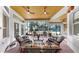 Covered porch with comfortable seating and ceiling fans at 3506 Cordgrass Dr, Valrico, FL 33596