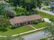 Aerial view highlights the house and spacious yard nestled in a leafy, residential area at 37821 Willingham Ave, Dade City, FL 33525