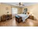 Comfortable bedroom features a wood-look floor, ceiling fan, and charming vintage decor at 37821 Willingham Ave, Dade City, FL 33525