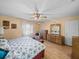 Bright bedroom with a ceiling fan, and a vanity with a mirror at 37821 Willingham Ave, Dade City, FL 33525