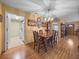 Traditional dining room featuring a wooden table, decorative plates, and a view into the kitchen at 37821 Willingham Ave, Dade City, FL 33525
