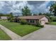 Exterior shot of the house with mature landscaping and an attached two-car garage at 37821 Willingham Ave, Dade City, FL 33525