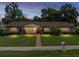 Charming single-story brick home with a well-manicured lawn and inviting front porch at 37821 Willingham Ave, Dade City, FL 33525