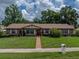 Beautiful brick home with manicured lawn, inviting entryway, and charming curb appeal at 37821 Willingham Ave, Dade City, FL 33525