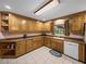 Cozy kitchen featuring oak cabinets, tiled backsplash, and ample counter space at 37821 Willingham Ave, Dade City, FL 33525