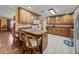 Open kitchen with oak cabinetry, tiled floors, and bar stool seating at the island at 37821 Willingham Ave, Dade City, FL 33525