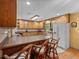Functional kitchen featuring oak cabinets, a white refrigerator and a spacious countertop at 37821 Willingham Ave, Dade City, FL 33525