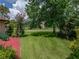 Well-manicured lawn with lush green grass and mature trees in a quiet neighborhood at 37821 Willingham Ave, Dade City, FL 33525