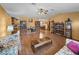 Spacious living room featuring wood floors, ceiling fan, and comfortable seating arrangements at 37821 Willingham Ave, Dade City, FL 33525