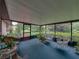 Relaxing screened-in porch with wicker furniture and views of the lush greenery at 37821 Willingham Ave, Dade City, FL 33525