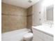 Bathroom featuring tiled shower-tub, neutral walls, modern vanity, and decorative mirror at 3805 Cortez Cir # B, Tampa, FL 33614