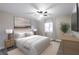 Bright bedroom features a ceiling fan, large window, neutral walls, and a comfortable bed at 3805 Cortez Cir # B, Tampa, FL 33614