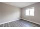 Empty bedroom featuring neutral walls, window with blinds, and light wood-look floors at 3805 Cortez Cir # B, Tampa, FL 33614