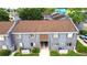 An aerial view of a two-story condominium showcasing the front facade, roof and green landscaping at 3805 Cortez Cir # B, Tampa, FL 33614