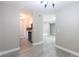 Hallway leading to kitchen and living room with neutral paint and grey wood-look floors at 3805 Cortez Cir # B, Tampa, FL 33614