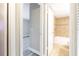 Hallway with open view into bathroom featuring tiled walls, a bathtub, and modern fixtures at 3805 Cortez Cir # B, Tampa, FL 33614