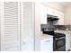 Bright kitchen featuring stainless steel appliances, white cabinets, and mosaic backsplash at 3805 Cortez Cir # B, Tampa, FL 33614