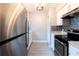 Galley kitchen with stainless steel appliances, white cabinets, and mosaic backsplash at 3805 Cortez Cir # B, Tampa, FL 33614