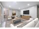 Open-concept staged living room featuring contemporary furnishings, a TV, and neutral decor for comfortable living at 3805 Cortez Cir # B, Tampa, FL 33614