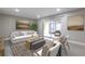 Staged living room featuring neutral decor, an open design, and sliding glass doors to the screened in patio at 3805 Cortez Cir # B, Tampa, FL 33614