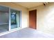 Patio with sliding glass door and exterior door; concrete flooring and tan walls at 3805 Cortez Cir # B, Tampa, FL 33614