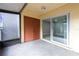 Exterior patio featuring sliding glass door, closet with tan walls and concrete flooring at 3805 Cortez Cir # B, Tampa, FL 33614