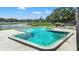 Community pool with patio and lounge chairs overlooking a serene lake at 3805 Cortez Cir # B, Tampa, FL 33614