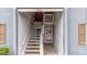 Exterior stairway leads to unit entrance; features wooden stairs and shutters on windows at 3805 Cortez Cir # B, Tampa, FL 33614
