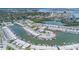 Aerial view of waterfront complex with canal access, boat docks, and beautifully landscaped grounds at 384 Boca Ciega Point Blvd, St Petersburg, FL 33708