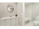 Bright bathroom featuring a dual-sink vanity and a tub-shower combination with marble-style tile surround at 384 Boca Ciega Point Blvd, St Petersburg, FL 33708