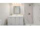 Clean bathroom featuring dual sinks and a shower with marble-like tiling at 384 Boca Ciega Point Blvd, St Petersburg, FL 33708