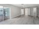 Open bedroom with light wood flooring, a ceiling fan, and a sliding glass door to an outdoor patio at 384 Boca Ciega Point Blvd, St Petersburg, FL 33708