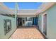 Private courtyard with seating, a blue door and terracotta pavers at 384 Boca Ciega Point Blvd, St Petersburg, FL 33708