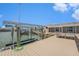 Well-maintained dock featuring a boat lift and outdoor seating area at 384 Boca Ciega Point Blvd, St Petersburg, FL 33708