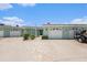 Charming home with multiple garages, tile walkway, and turquoise colored paint at 384 Boca Ciega Point Blvd, St Petersburg, FL 33708