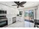 Modern kitchen featuring stainless steel appliances, white cabinets, and access to the courtyard at 384 Boca Ciega Point Blvd, St Petersburg, FL 33708