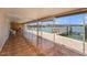 Enclosed lanai featuring tile flooring, ceiling fans, and sliding glass doors with waterfront views and dock access at 384 Boca Ciega Point Blvd, St Petersburg, FL 33708