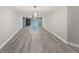 Spacious living room boasts hard wood flooring and sliding glass doors with waterfront views at 384 Boca Ciega Point Blvd, St Petersburg, FL 33708