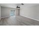 Bright living room featuring modern flooring and a sliding glass door with waterfront views at 384 Boca Ciega Point Blvd, St Petersburg, FL 33708