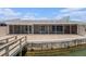 Water view of the patio and enclosure, leading to the dock and canal at 384 Boca Ciega Point Blvd, St Petersburg, FL 33708