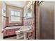 Bathroom with shower, pedestal sink, commode, and pink tile at 4435 1St S Ave, St Petersburg, FL 33711